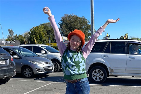 teenager with arms in air