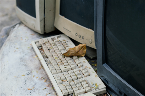 Ewaste old desktop computers covered in dust.png